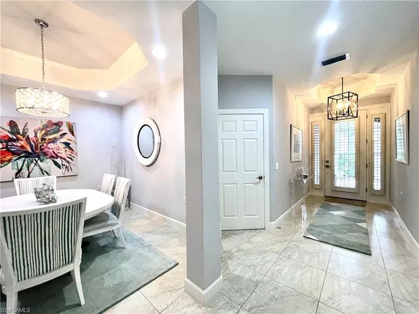 a view of a hallway with furniture and windows