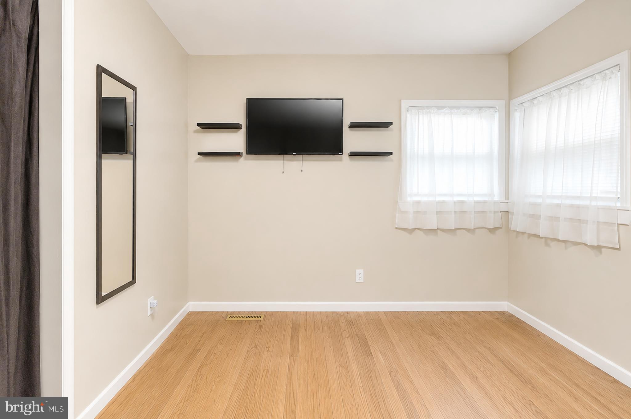 32 Bryant Road Turnersville, NJ 08012 - Photo 21 of 33 a view of an empty room with wooden floor and a window