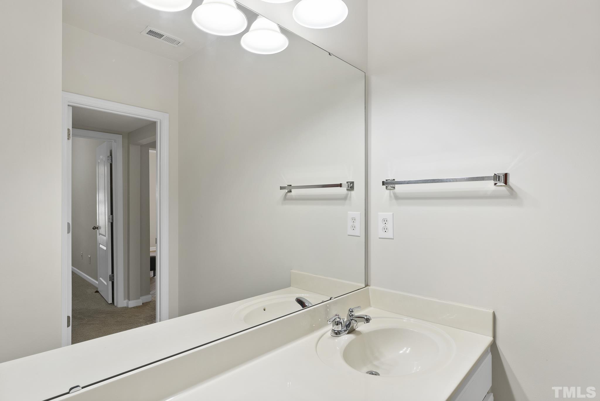 3306 Colorcott Street Raleigh, NC 27614 - Photo 38 of 42 a bathroom with a sink and a mirror