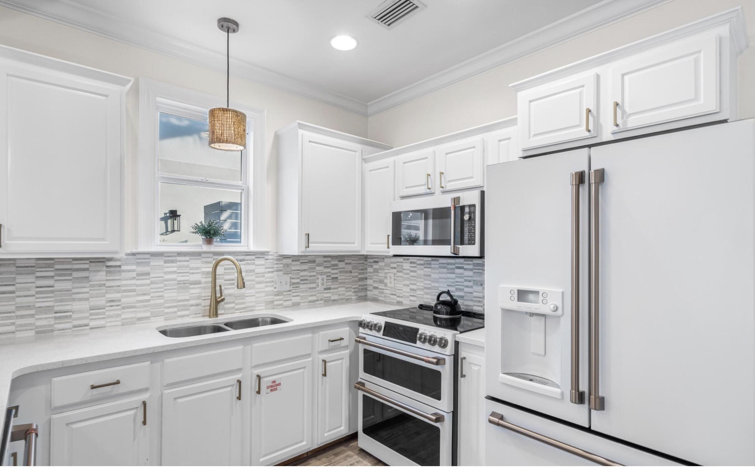 61 West Seacrest Beach Blvd Inlet Beach Inlet Beach, FL 32461 - Photo 11 of 47 a kitchen with stainless steel appliances granite countertop a sink a stove and a refrigerator