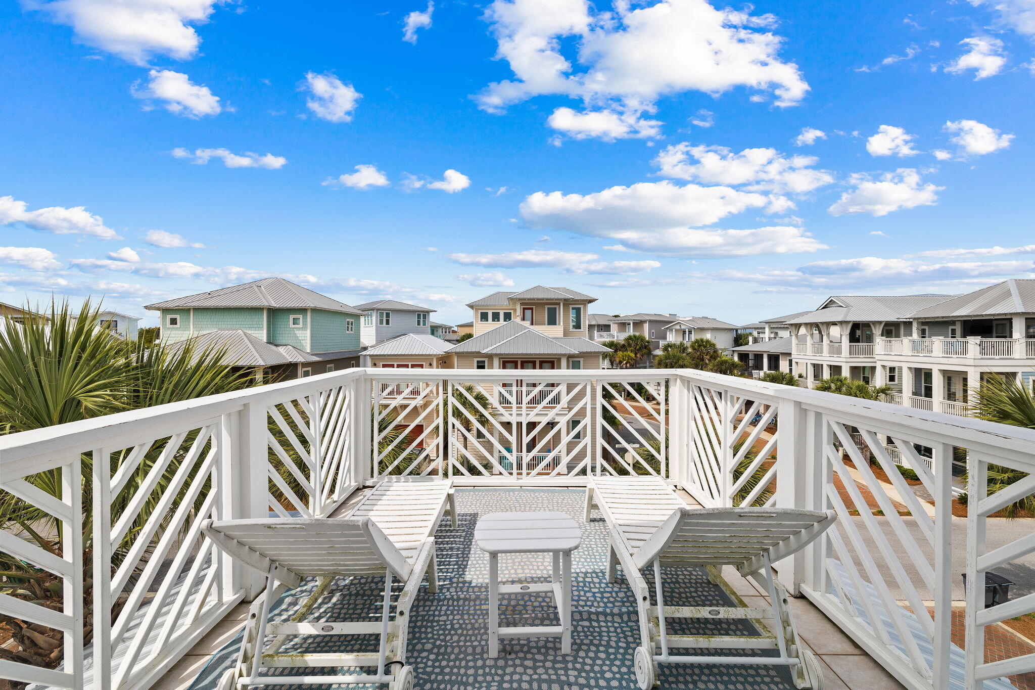 61 West Seacrest Beach Blvd Inlet Beach Inlet Beach, FL 32461 - Photo 40 of 47 a balcony with table and chairs