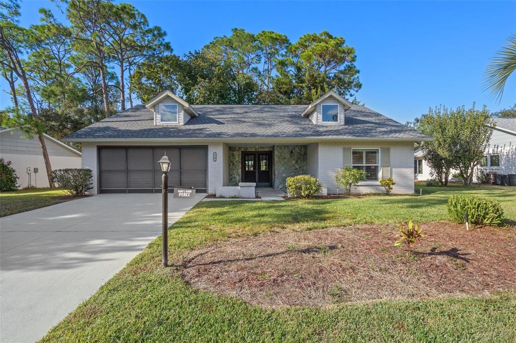 6147 Turnburry Court Spring Hill, FL 34606 - Photo 1 of 31 a front view of a house with garden