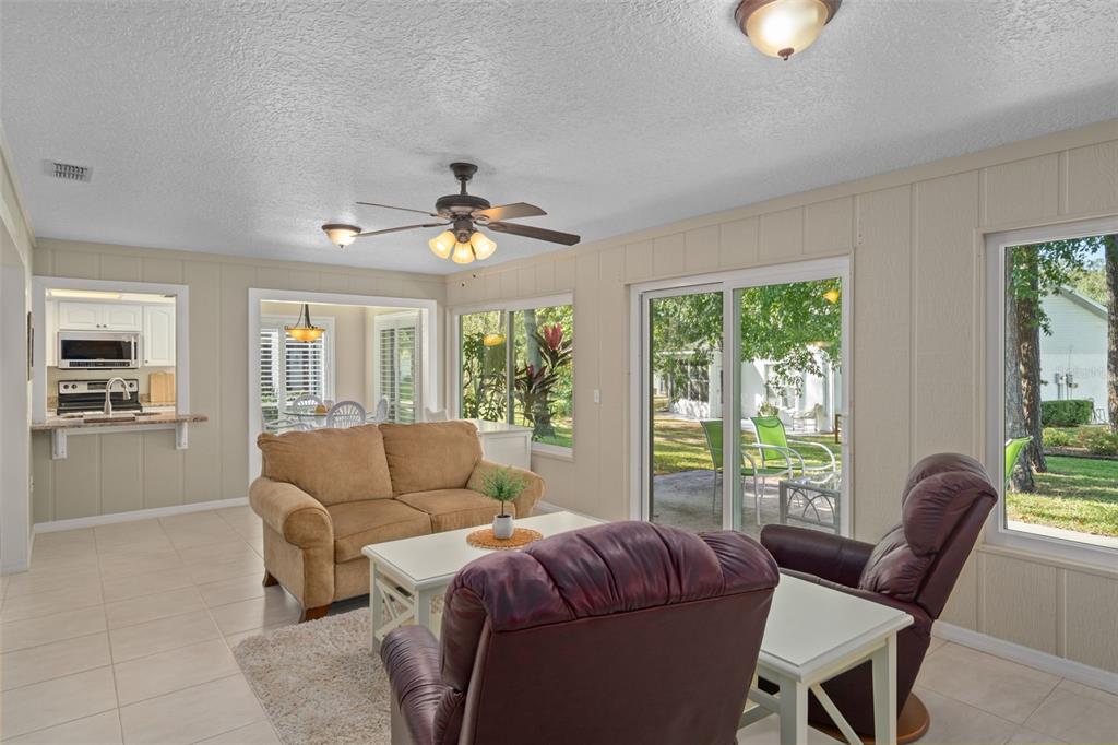 6147 Turnburry Court Spring Hill, FL 34606 - Photo 13 of 31 a living room with furniture and a large window