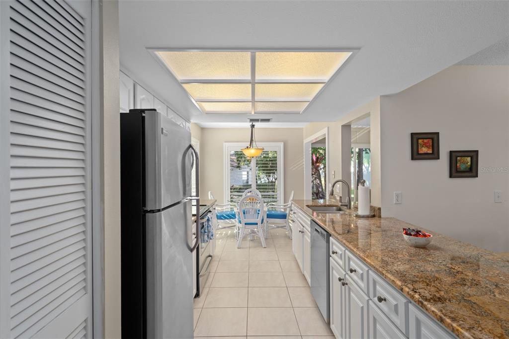 6147 Turnburry Court Spring Hill, FL 34606 - Photo 18 of 31 a kitchen with stainless steel appliances granite countertop a refrigerator and a sink