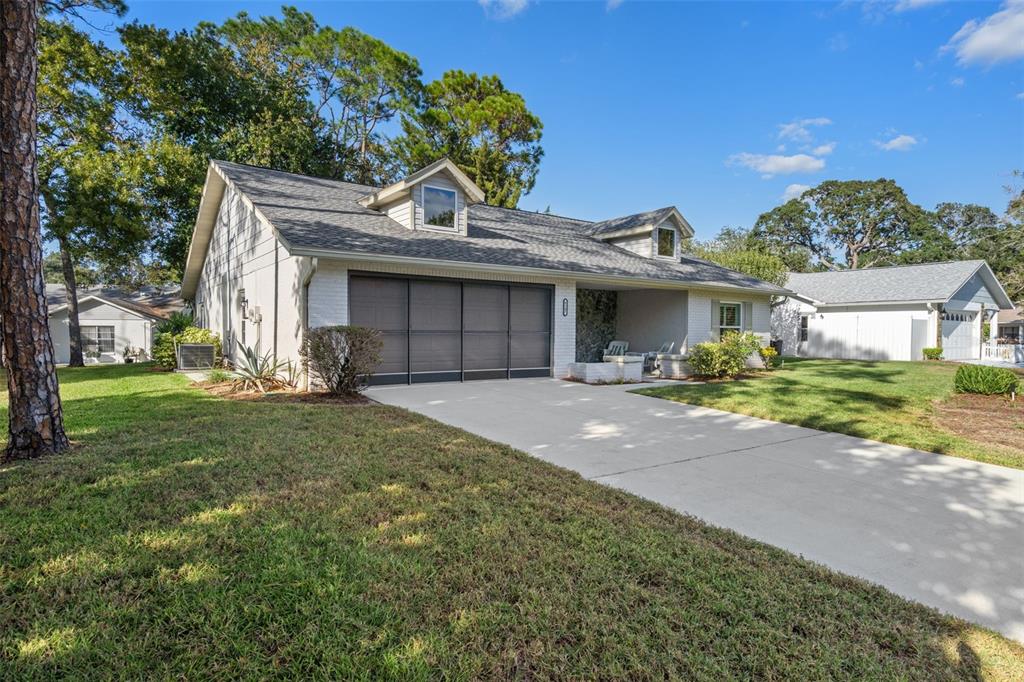 6147 Turnburry Court Spring Hill, FL 34606 - Photo 2 of 31 a front view of a house with a yard