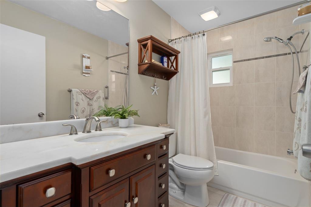 6147 Turnburry Court Spring Hill, FL 34606 - Photo 23 of 31 a bathroom with a sink a toilet and shower