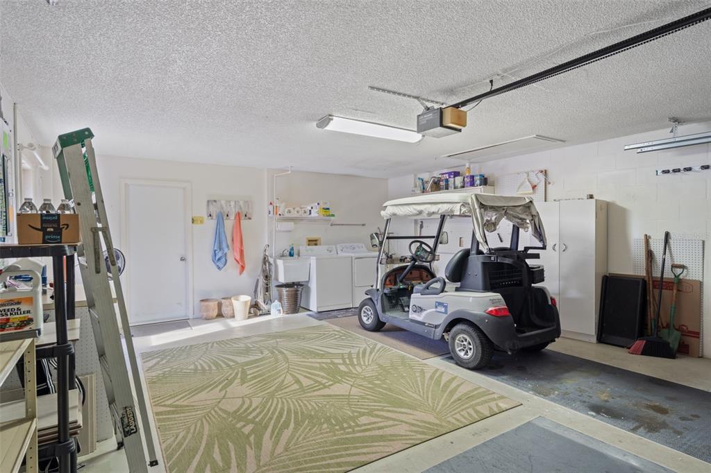6147 Turnburry Court Spring Hill, FL 34606 - Photo 26 of 31 a utility room with dryer and bicycles