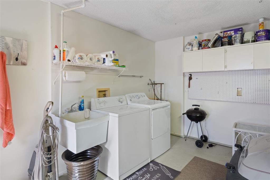 6147 Turnburry Court Spring Hill, FL 34606 - Photo 27 of 31 a utility room with sink dryer and washer