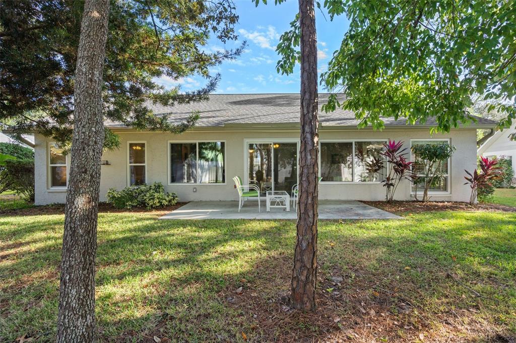 6147 Turnburry Court Spring Hill, FL 34606 - Photo 30 of 31 a view of a house with backyard porch and sitting area