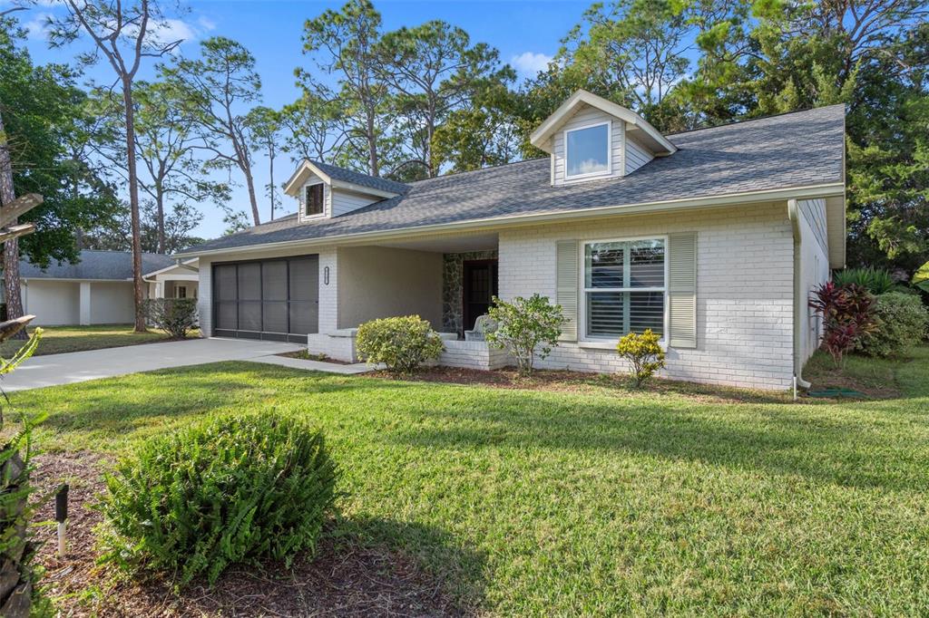 6147 Turnburry Court Spring Hill, FL 34606 - Photo 3 of 31 a view of a house with a yard and plants