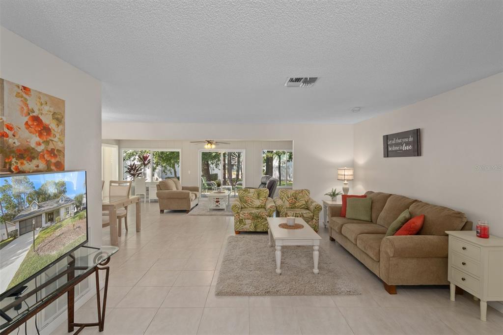6147 Turnburry Court Spring Hill, FL 34606 - Photo 8 of 31 a living room with furniture and a flat screen tv