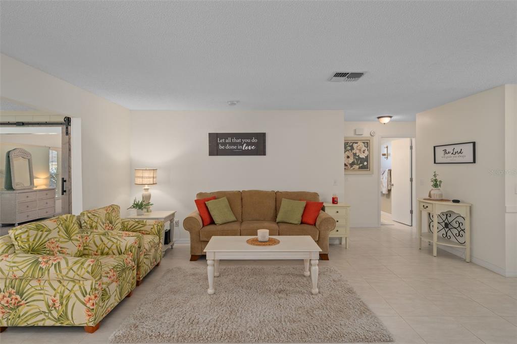 6147 Turnburry Court Spring Hill, FL 34606 - Photo 10 of 31 a living room with furniture and painting on the wall