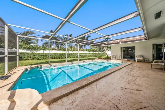 a view of a backyard with swimming pool