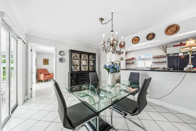 a dining room with furniture a rug and a chandelier