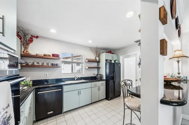 a kitchen with stainless steel appliances granite countertop a sink and a stove