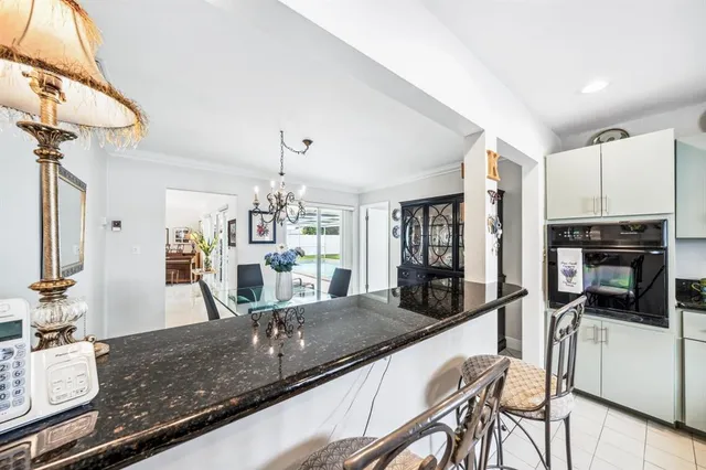 a kitchen with granite countertop a sink and a stove top oven
