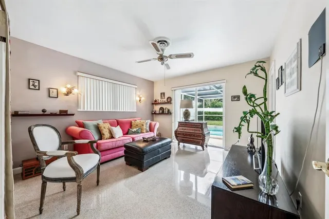 a living room with furniture potted plant and a window