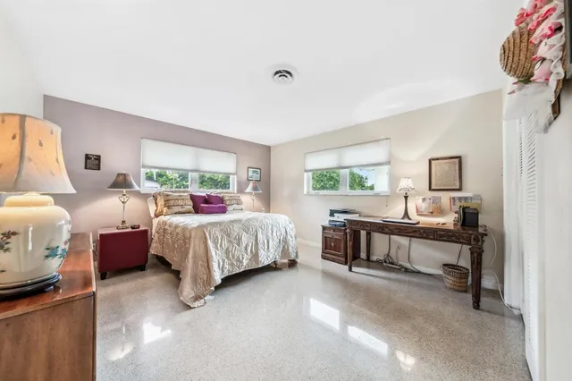 a bedroom with a bed and a large window