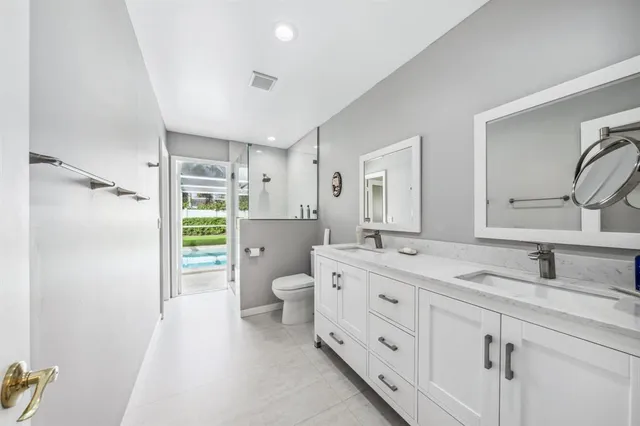 a spacious bathroom with a granite countertop sink mirror and toilet