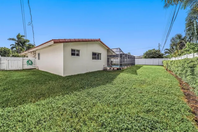 a house with green field in front of it