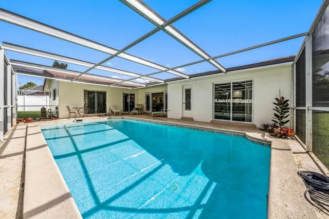 a view of a backyard with table and chairs under an umbrella