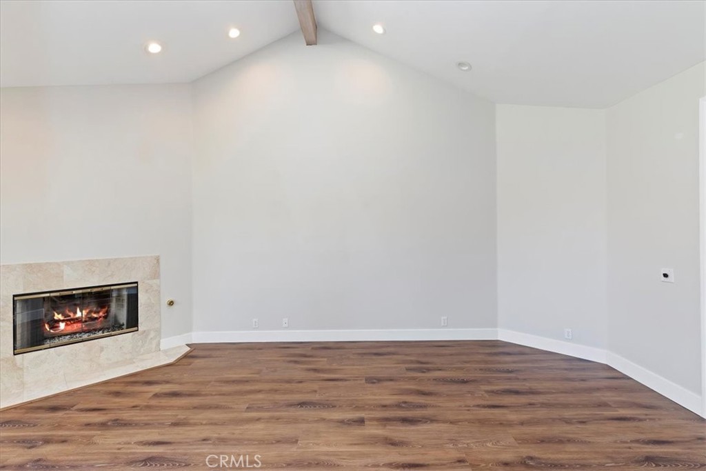 1507 Weston Way Riverside, CA 92506 - Photo 12 of 55 a view of an empty room with wooden floor and a fireplace