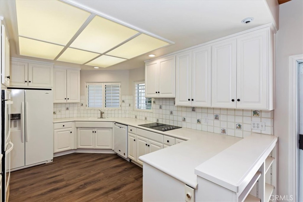 1507 Weston Way Riverside, CA 92506 - Photo 17 of 55 a kitchen with white cabinets and white appliances