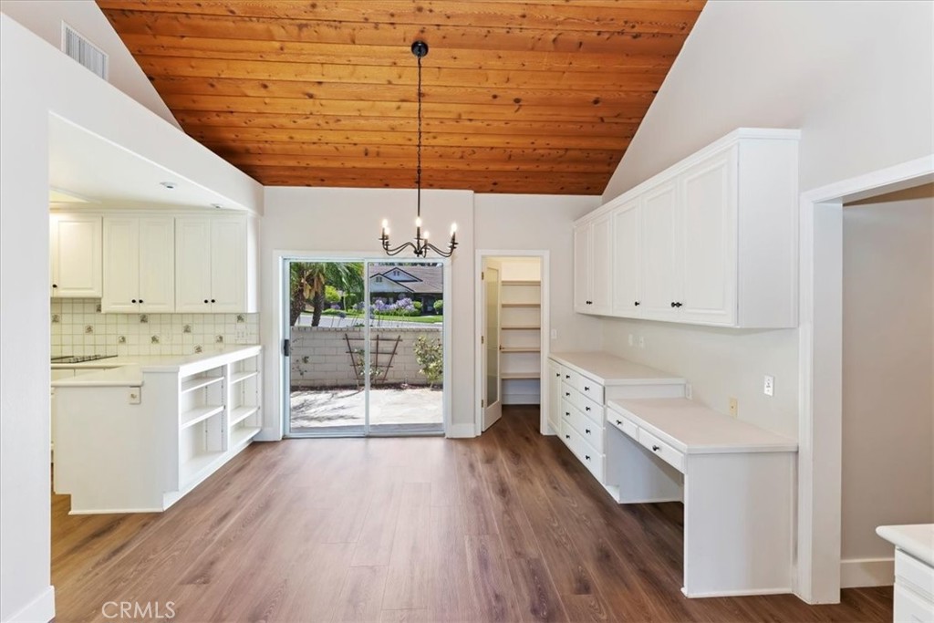 1507 Weston Way Riverside, CA 92506 - Photo 21 of 55 a large kitchen with a wooden floor and cabinets