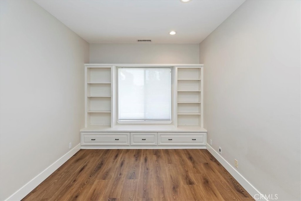 1507 Weston Way Riverside, CA 92506 - Photo 26 of 55 an empty room with a wooden floor and white walls