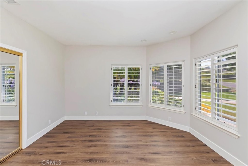 1507 Weston Way Riverside, CA 92506 - Photo 30 of 55 a view of an empty room with wooden floor and a window