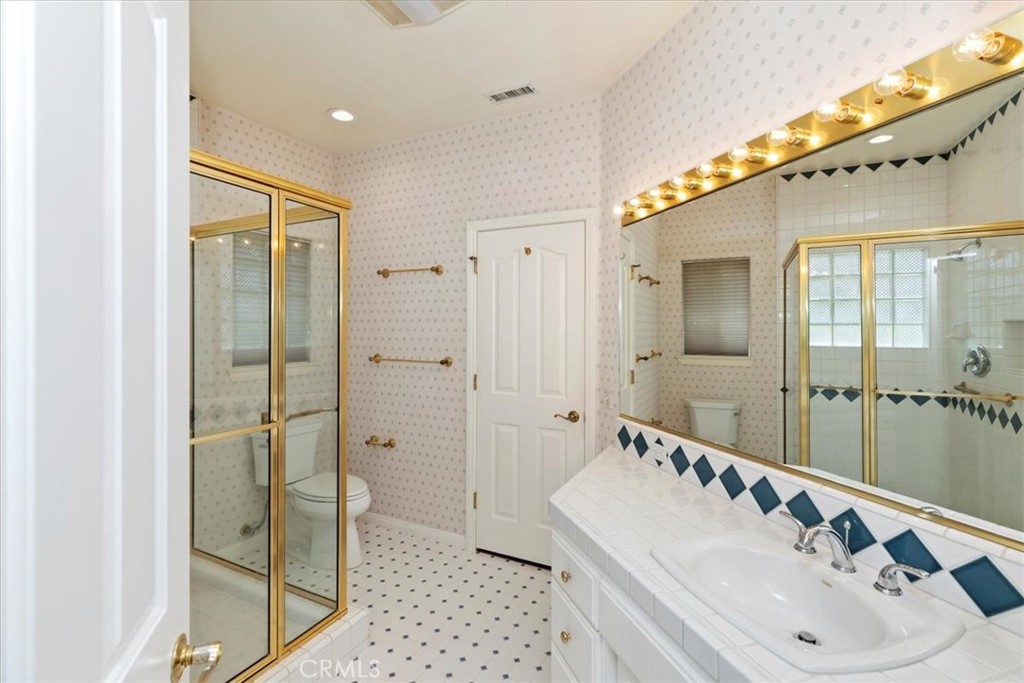 1507 Weston Way Riverside, CA 92506 - Photo 34 of 55 a bathroom with a double vanity sink mirror and shower