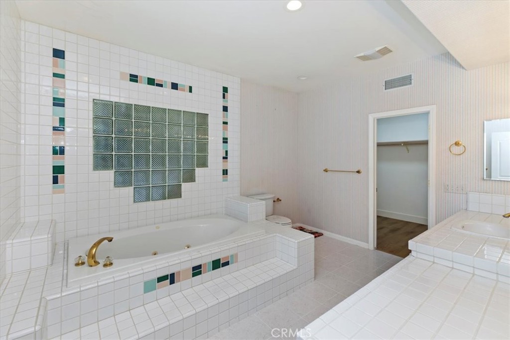1507 Weston Way Riverside, CA 92506 - Photo 41 of 55 a bathroom with a tub a window and a shower