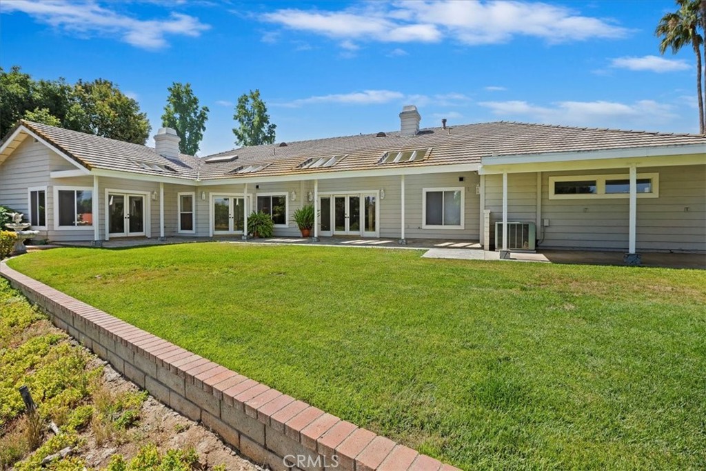 1507 Weston Way Riverside, CA 92506 - Photo 44 of 55 a front view of a house with a garden and trees