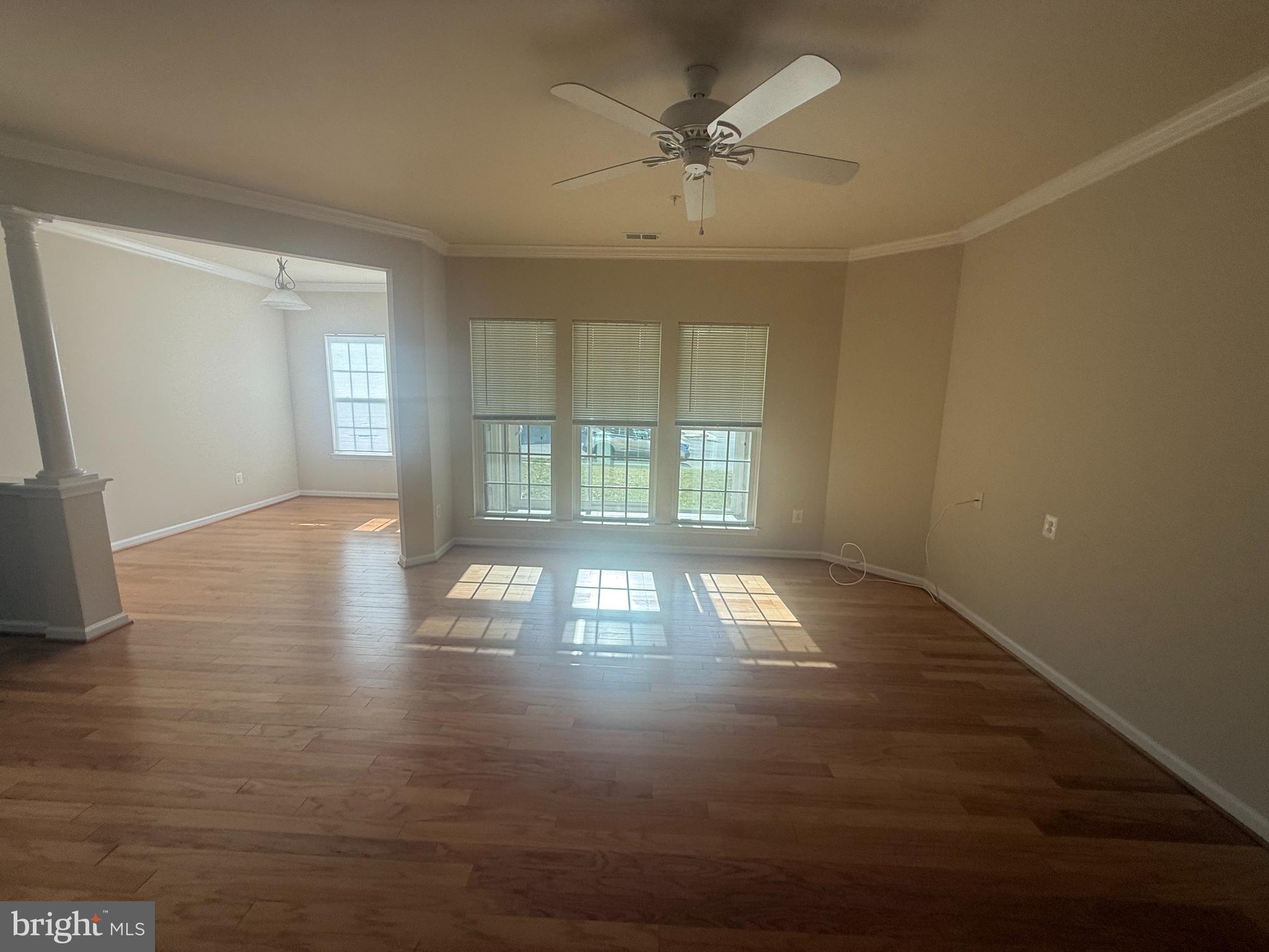 8470 Ice Crystal Drive, Unit B Laurel, MD 20723 - Photo 12 of 14 an empty room with wooden floor and windows