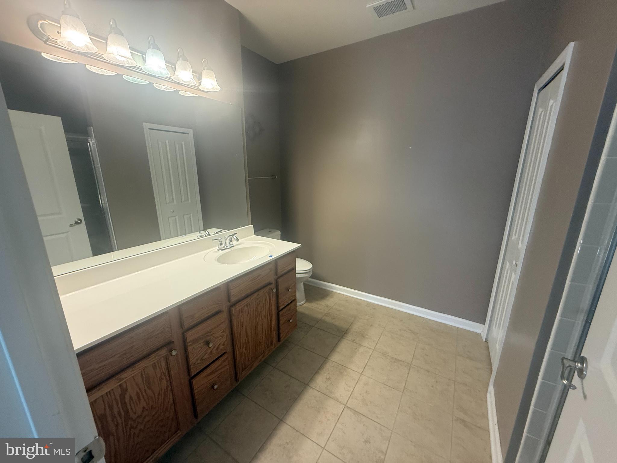 8470 Ice Crystal Drive, Unit B Laurel, MD 20723 - Photo 4 of 14 a bathroom with a sink and a mirror