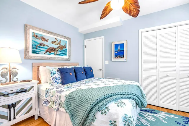 a bedroom with a bed and a painting on the wall