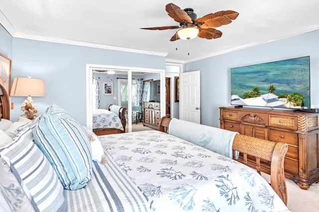 a bedroom with a bed and ceiling fan