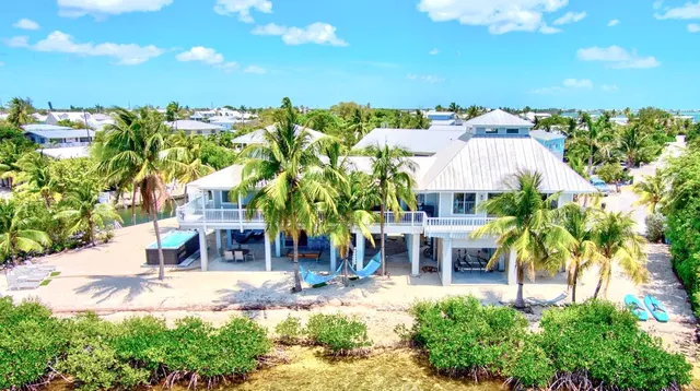 a view of a patio with table and chairs and potted plants