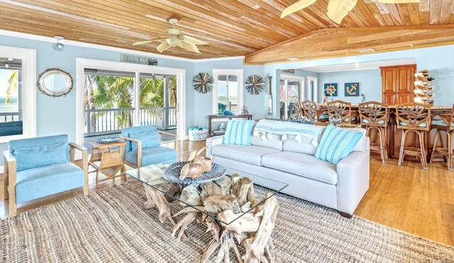 a living room with furniture dining table and a large window