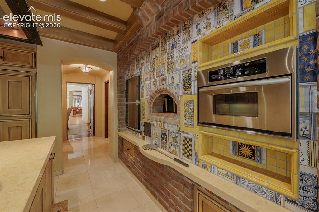 4530 Governors Point Colorado Springs, CO 80906 - Photo 34 of 49 Commercial pizza oven in gourmet kitchen with hand painted tiles