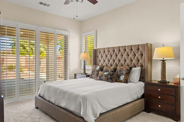 a bedroom with a bed and a night stand