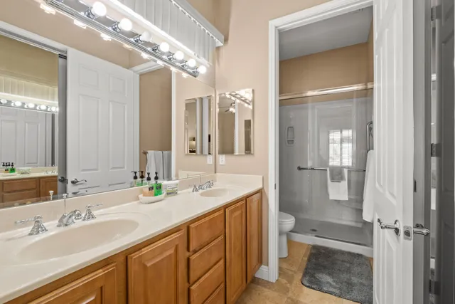 a bathroom with a double vanity sink mirror and double