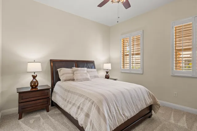 a bedroom with a bed and windows