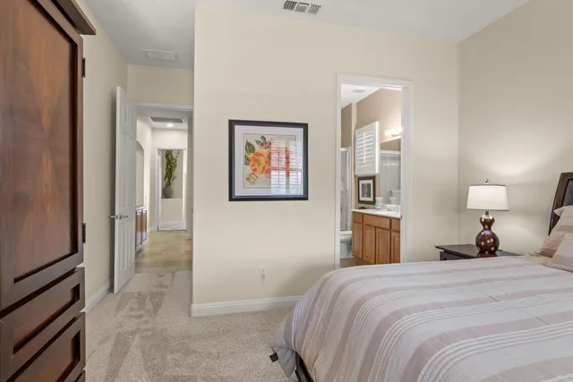 a bedroom with a bed and a painting on the wall