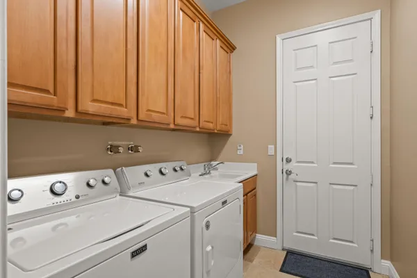 a view of washer and dryer with kitchen in the background