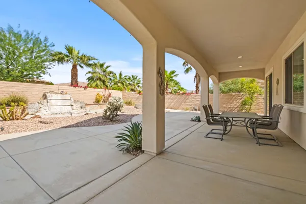 a view of a patio with table and chairs and potted plants