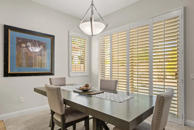 a view of a dining room with furniture and window
