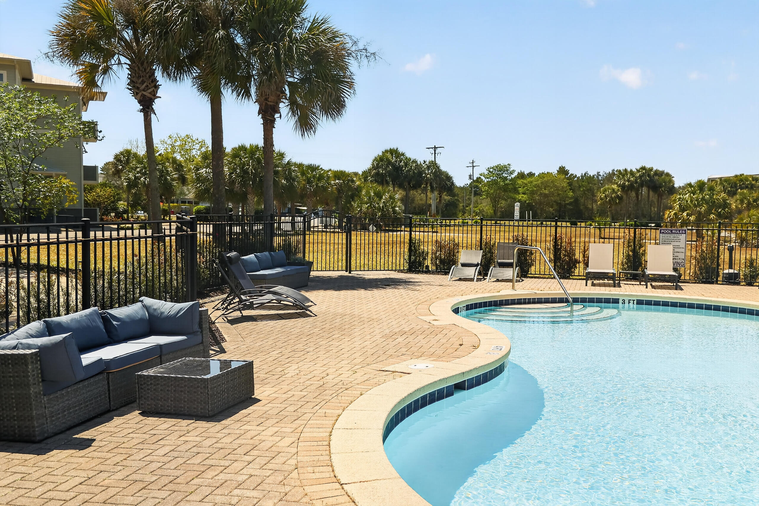 6904 West County Highway 30A, Unit MULTIPLE Santa Rosa Beach, FL 32459 - Photo 15 of 16 a view of a swimming pool with a couches and sky view