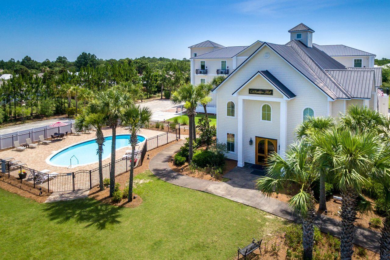 6904 West County Highway 30A, Unit MULTIPLE Santa Rosa Beach, FL 32459 - Photo 5 of 16 a view of a house with a yard and sitting area