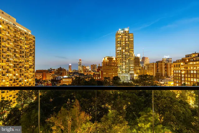 a living room with furniture and large windows